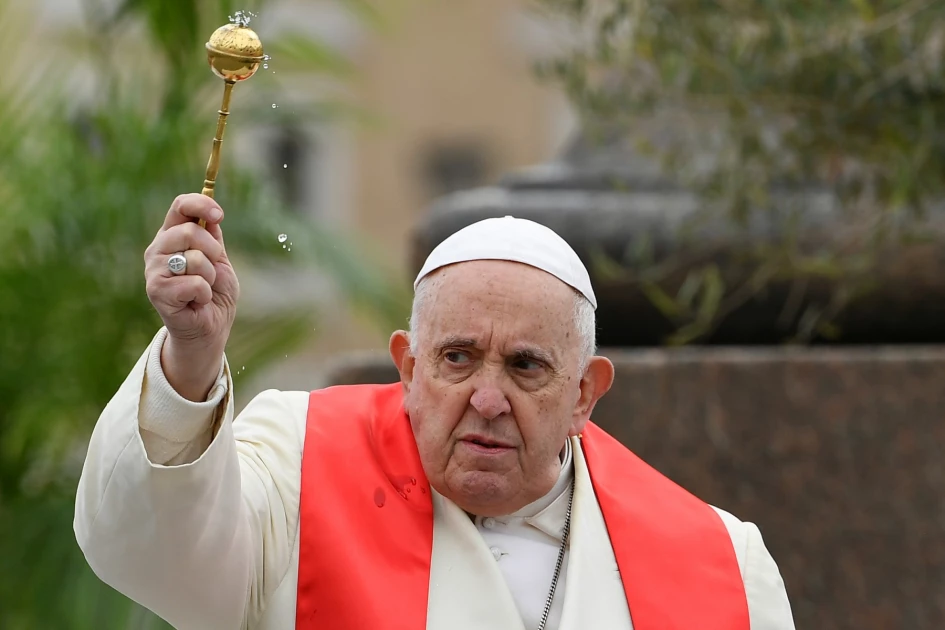 Pope Francis blesses the olive branches as he leads the Palm Sunday mass on April 2, 2023 at St. Peter's square in The Vatican. (Photo by Filippo MONTEFORTE / POOL / AFP)